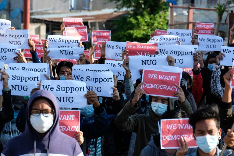 Protesters hold posters in support of the NUG during a demonstration against the military coup in the Shan State capital Taunggyi on May 2, 2021. (AFP)