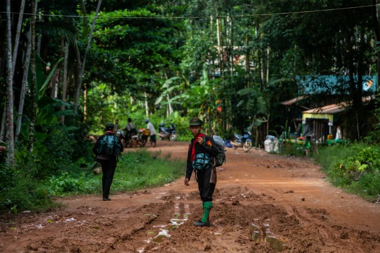 A member of the People’s Liberation Army stands at the entrance of a village controlled by the resistance in Tanintharyi Region on October 16. (Mar Naw | Frontier)