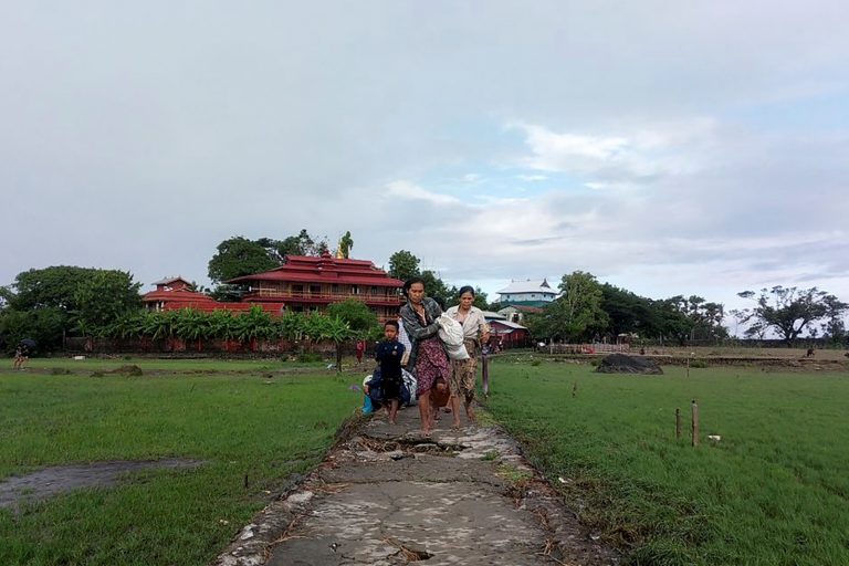 People flee clashes between the Myanmar military and Arakan Army in Rakhine State’s Pauktaw Township on November 19, 2023. (AFP)