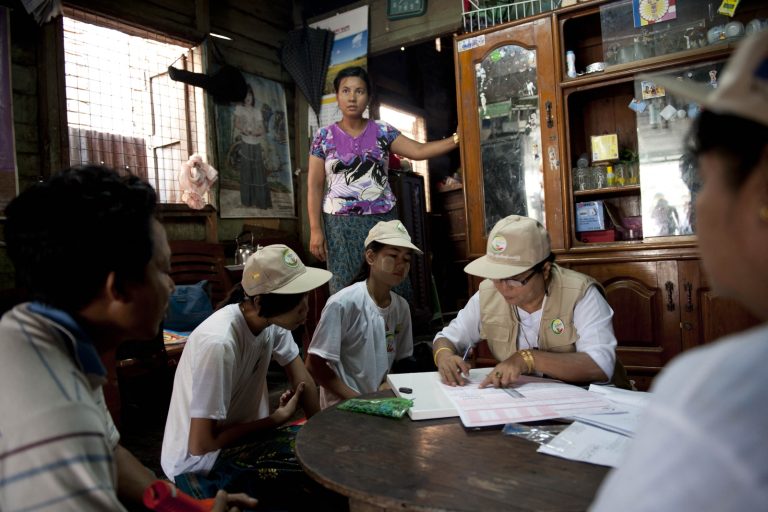 Enumerators collect census data from a family in Yangon on March 30, 2014. (AFP)