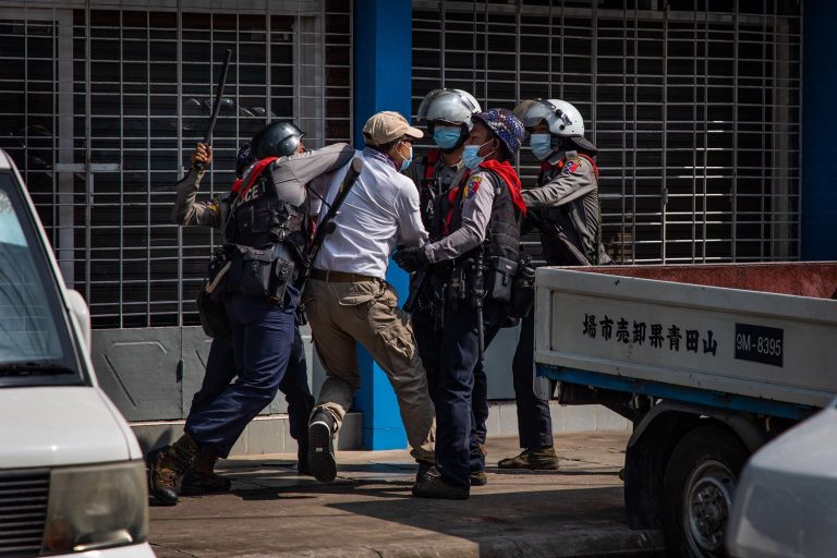 Police arrest a protester in Yangon's Sanchaung Township this afternoon. (Frontier)