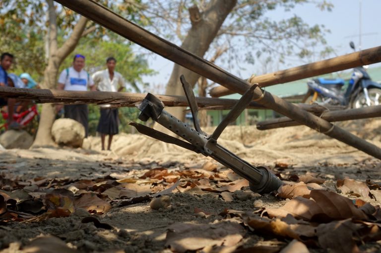 People look at an unexploded rocket in Rakhine State’s Mrauk-U Township on March 16, 2019. (AFP)