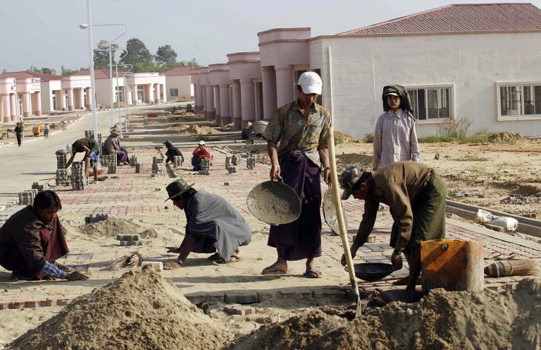 Labourers construct a pavement in a residential quarter of Nay Pyi Taw in December 2007. (AFP)