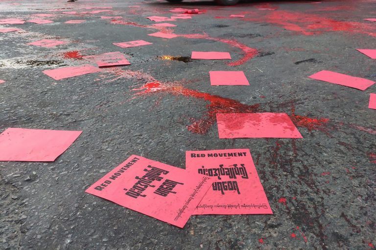 Anti-coup protesters in Yangon splash red paint on the ground and scatter flyers on April 10 in a student-led "Red Movement" to commemorate the killing of hundreds of protesters by security forces. (Facebook / AFP)