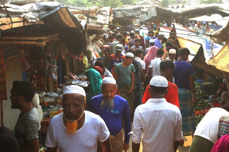 Rohingya refugees walk through a market inside a refugee camp in Ukhia, Bangladesh on April 6. (AFP)