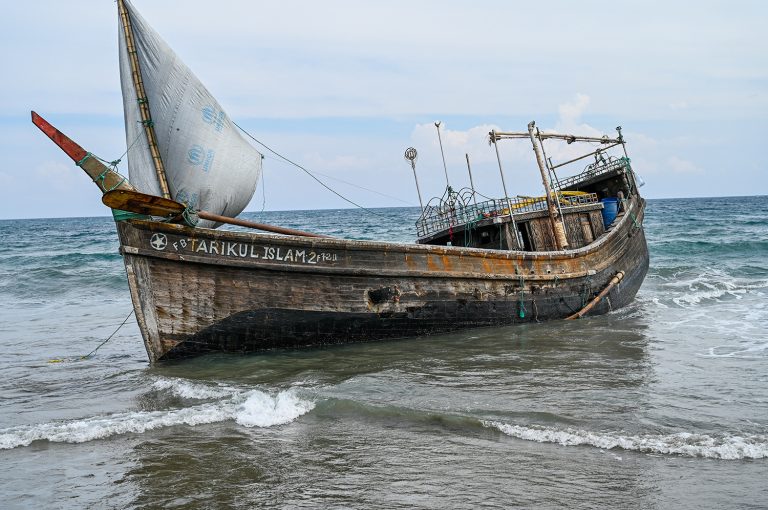 A boat that carried Rohingya refugees after their arrival at a beach in Indonesia's Aceh province on December 25, 2022. (AFP)