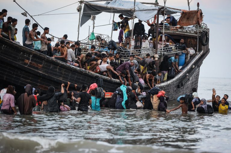 Newly arrived Rohingya refugees return to a boat after the local community decided to temporarily allow them to land for water and food in Aceh province, Indonesia, on November 16. (AFP)