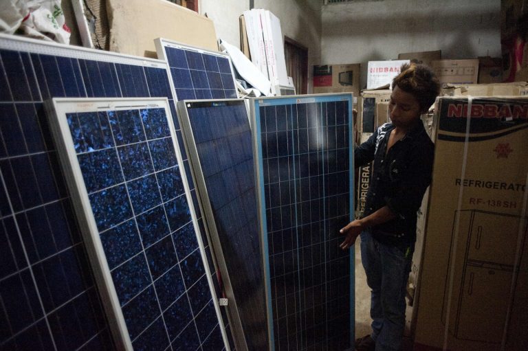 A man selling solar panels at his shop in the Kayah State capital of Loikaw on October 13, 2014. (AFP)