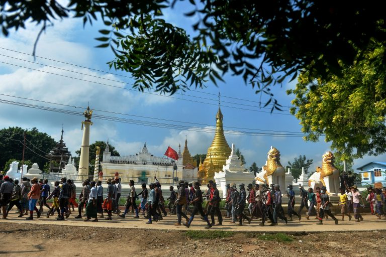 Protesters escorted by resistance fighters take part in a demonstration against the military coup in Sagaing Township on September 7, 2022. (AFP)