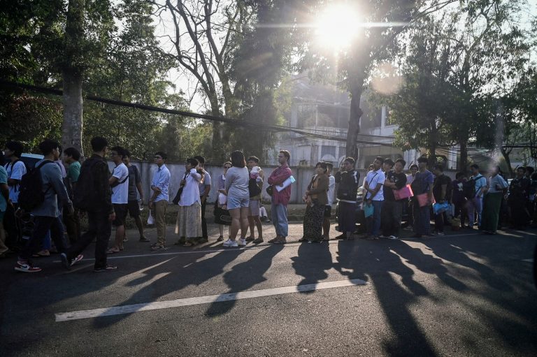 Myanmar people queue outside the Thai embassy in Yangon today, after the junta announced on Saturday it would enforce mandatory military service. (AFP)