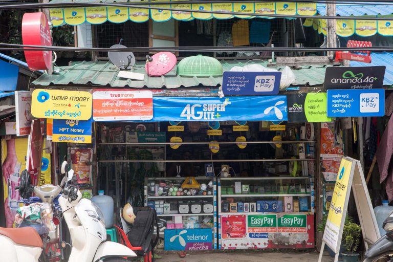 A shop in Yangon's Insein Township adorned with mobile money signs on July 8. (Thuya Zaw | Frontier)