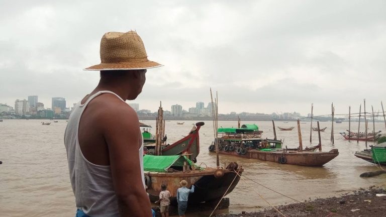 The diver Thant Zin Oo watches over his team working in the Yangon River in June (Moe Thaw Dar Swe | Frontier)