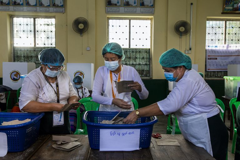 Union Election Commission officials prepare to count advance ballots at the No 5 polling station in Yangon's Mingalar Taung Nyunt Township on November 8. (Hkun Lat | Frontier)