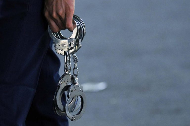 A Myanmar policeman carries handcuffs in this picture taken in 2019. (Frontier)