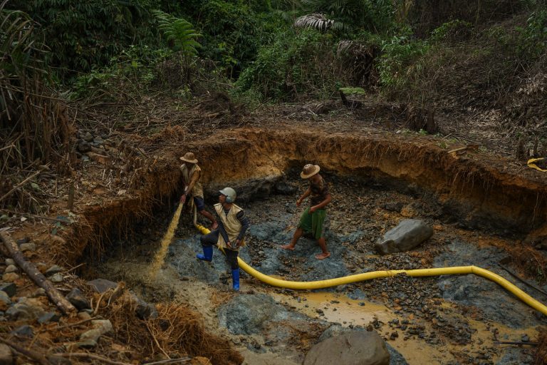 Gold miners near Nam San Yang use a pressure hose to dislodge sediment to extract gold. The process also involves the use of mercury, which locals worry will contaminate the water (Yawng Htang | Frontier)