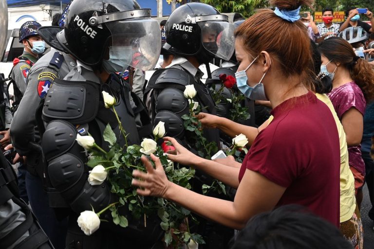 Protesters appeal to police to join them in the days following the coup in February of last year (AFP)