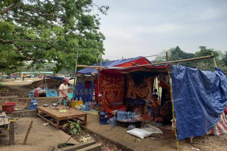 Civil service families on April 7 live in crude shacks they built themselves on a football field near their ruined homes in Nay Pyi Taw's Zabuthiri Township. (Frontier)