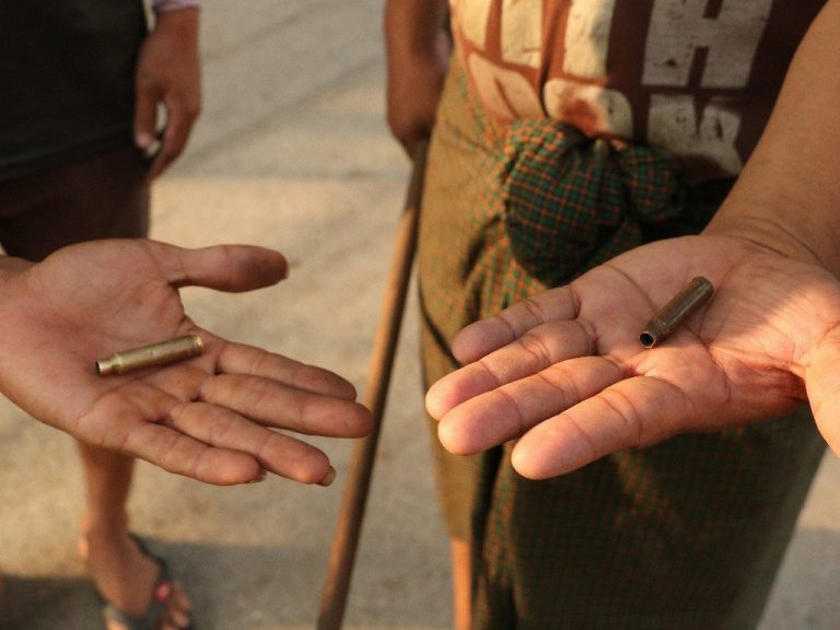 Residents of Yangon's South Dagon Township display bullet casings from live rounds fired at civilians by soldiers and police there on March 28, a brutal day of crackdowns that left multiple dead and included the military's use of live grenades on civilians. (Frontier)